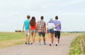 Group of teenagers walking outdoors from back