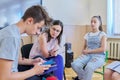 Group of teenagers with teacher at classroom, sitting talking discussing Royalty Free Stock Photo