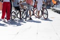 Group of teens kids with bicycles, one person standing on a ramp Royalty Free Stock Photo