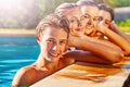 Group of teens in row on swimming pool border