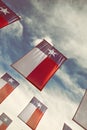 A group of Texas flags against blue sky and white clouds Royalty Free Stock Photo