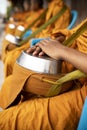 Group of thai monk wearing yellow clothes and holding buddhist bowl waiting for buddhist people offering morning food