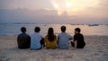 Group of Thai people, Asian friends, clanging bottles of beer together and celebrating on holiday in party at the beach or sea in Royalty Free Stock Photo