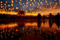 Group of Thai people release sky floating lanterns or lamp to worship Buddha\'s relics with reflection