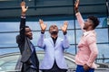 A group of their three successful African American businessmen in a stylish suit talking and rejoicing on the street Royalty Free Stock Photo