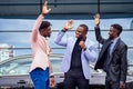 A group of their three successful African American businessmen in a stylish suit talking and rejoicing on the street Royalty Free Stock Photo