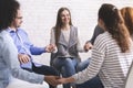 Group of addicted people holding hands, sitting in circle of trust Royalty Free Stock Photo