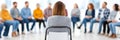 Group Therapy Session Support Woman sits in a circle of people during a group therapy session focused on support and healing Royalty Free Stock Photo