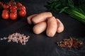 group of thick short sausages with onion, dill, and tomatoes Royalty Free Stock Photo