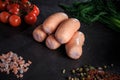 group of thick short sausages with onion, dill, and tomatoes Royalty Free Stock Photo