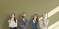 Group of serious people thinking over question and looking up at copy space above Royalty Free Stock Photo