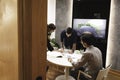 A group of three architects talking and discussing about making decision in a fancy elegant office. A beautiful business woman