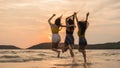 Group of three Asian young women jumping on beach, friends happy relax having fun playing on beach near sea when sunset in evening Royalty Free Stock Photo