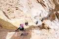 Group of three backpackers hiking desert canyon. Royalty Free Stock Photo