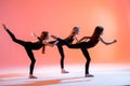 group of three ballet girls in black tight-fitting suits dancing on red background with their long hair down