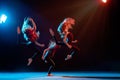 Group of three ballet girls in tight-fitting costumes jumping on black background with their long hair down, silhouettes Royalty Free Stock Photo