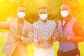 A group of three black men in stylish suits a meeting in a summer park. African-Americans friends hispanic businessman Royalty Free Stock Photo