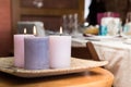 Group of three burning candles in the home. Candles of pink tones in a warm house