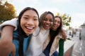 Group of three cheerful female friends looking at the camera hugging each other Happy girls outdoors Royalty Free Stock Photo