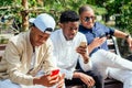 A group of three fashionable well-dressed cool African American guys students communicating on the street