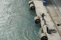 Group of three fishermen catching fishes using a net in port of Damietta, Egypt in container terminal.