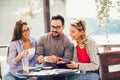 Group of three friends having fun a coffee together. Royalty Free Stock Photo