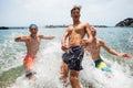 Group of three friends having fun together at the beach enjoying summer and looking at the camera - vacations at the beach in the Royalty Free Stock Photo