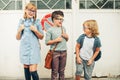 Group of three funny kids wearing backpacks walking back to school Royalty Free Stock Photo