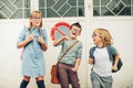 Group of three funny kids wearing backpacks walking back to school Royalty Free Stock Photo