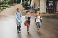 Group of three funny kids wearing backpacks walking back to school Royalty Free Stock Photo