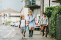 Group of three funny kids wearing backpacks walking back to school Royalty Free Stock Photo