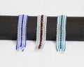 a group of three hand stitched flat beaded bracelets