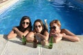 group of three happy beautiful girl friends having bath in swimming pool together having fun