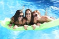 Group of three happy and beautiful young girl friends having bat