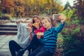Group of a three happy children taking selfie by smart phone while eating pizza outdoors Royalty Free Stock Photo