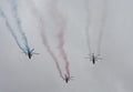 Group of three helicopters with colour smoke on the sky on military parade