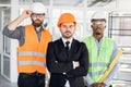 Group of three multi ethnic men checking construction object