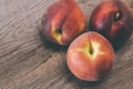 Group of three peaches on wooden background Royalty Free Stock Photo