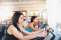 Group of three people in the gym, exercising their legs doing cardio training Royalty Free Stock Photo