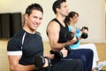 Group of three people training with dumbbells Royalty Free Stock Photo