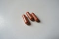 Group of 3 pink capsules of PQQ dietary supplement Royalty Free Stock Photo