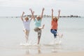 Group of three senior mature retired women on their 60s having fun enjoying together happy walking on the beach smiling playful Royalty Free Stock Photo