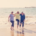 Group of three senior women walking having having fun on beach. Friendship and retirement lifestyle Royalty Free Stock Photo