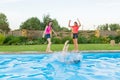 Group of three teenage girlfriends having fun in swimming pool Royalty Free Stock Photo