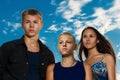 A group of three teenagers on the beach purposeful