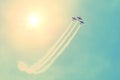 Group of three turboprop aircraft flying in the sky sun shine leaving a white smoky trail