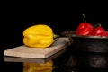 Hot chili habanero isolated on black glass