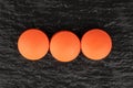 Orange pharmacy tablet on grey stone