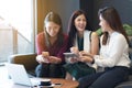 Group three women meeting in a coffee shop chatting to each other while using smartphone tablet and laptop, internet of things co