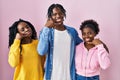 Group of three young black people standing together over pink background smiling doing phone gesture with hand and fingers like Royalty Free Stock Photo
